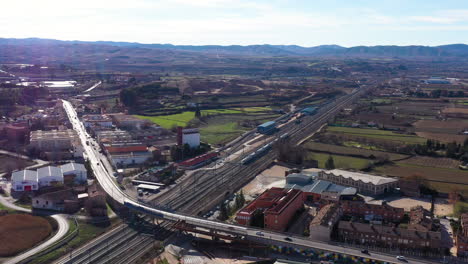 Train-passing-the-city-of-Catalayud-Spain-aerial-view-sunny-day-railway-station